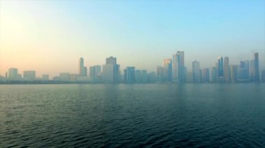 urban background morning cityscape with skyscrapers blue sky reflecting in blue sea and big metropolis
