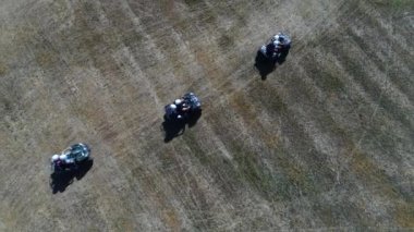 aerial vertical view of a group of atv riders quad vehicles sunny day france