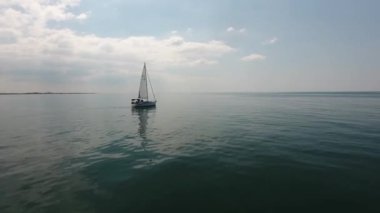 beautiful cinematic drone shot flying around a sailboat over mediterranean sea beautiful sunny afternoon low altitude flight location south of france