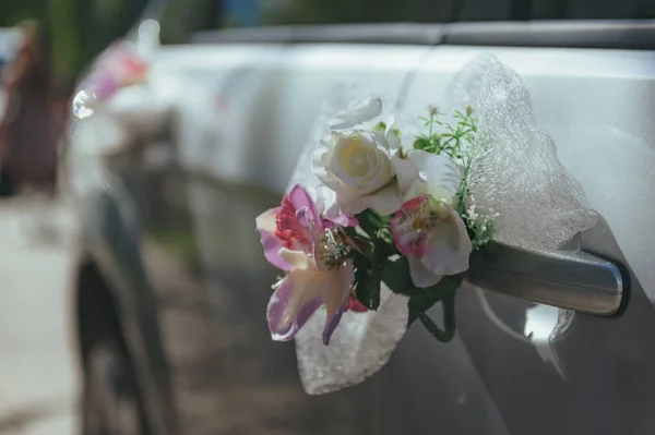 wedding car.Wedding decoration on wedding car.Luxury wedding car decorated with flowers.just married sign and cans attached