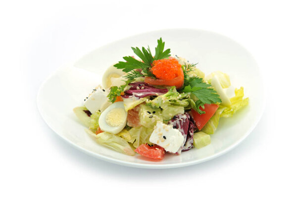 fresh salad with caviar and salmon on white bowl 