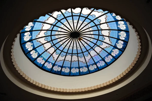 Round stained glass window. A beautiful delicately assembled stained glass round window in ceiling.
