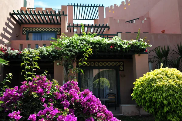 Beautiful garden at hotel resort and building in traditional arabic style. Resort architecture in Egypt