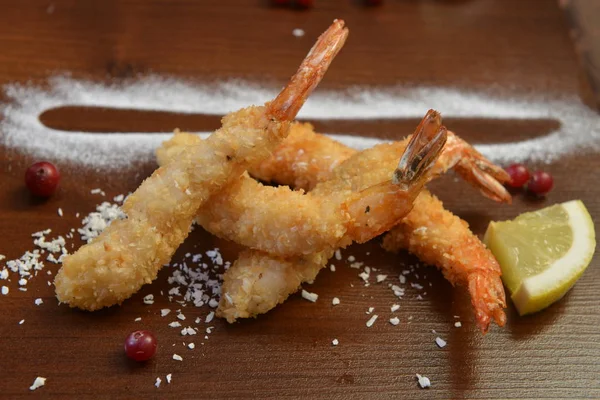 shrimp fried in breadcrumbs. deep fried shrimp meat ball on wooden table.