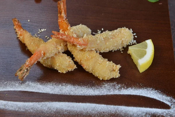 shrimp fried in breadcrumbs. deep fried shrimp meat ball on wooden table.