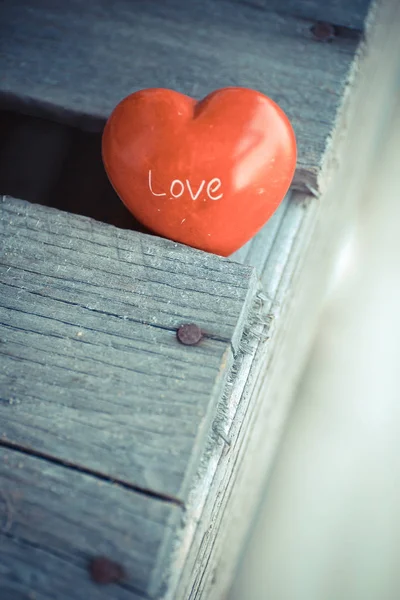 Красное сердце на деревянном столе — стоковое фото