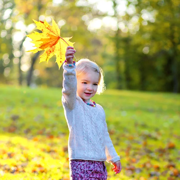 Küçük kız ormanda veya parkta güneşli bir gün zevk