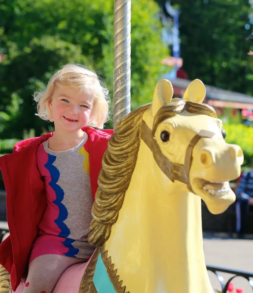 Ragazzina godendo merry-go-round al parco — Foto Stock