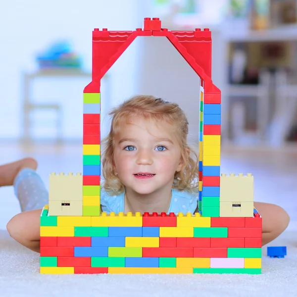 Little girl playing with construction bricks indoors — Stock Photo, Image