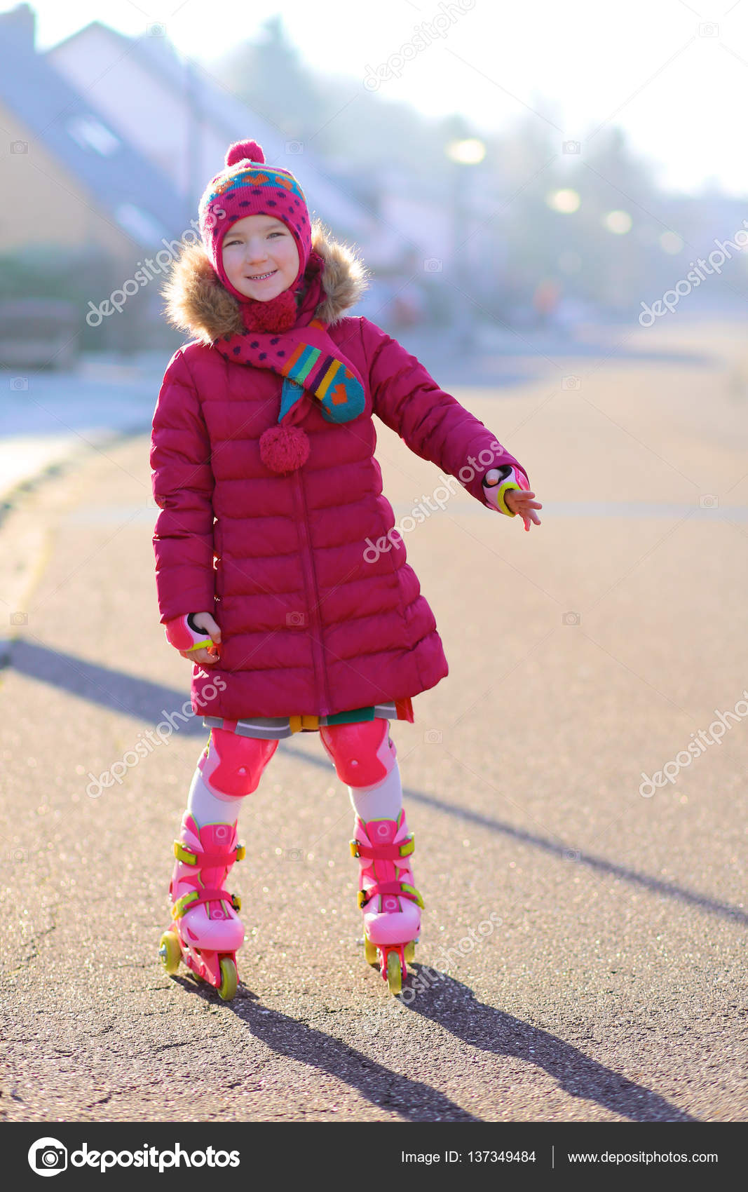 Happy little girl roller skating on the street Stock Photo by ©CroMary