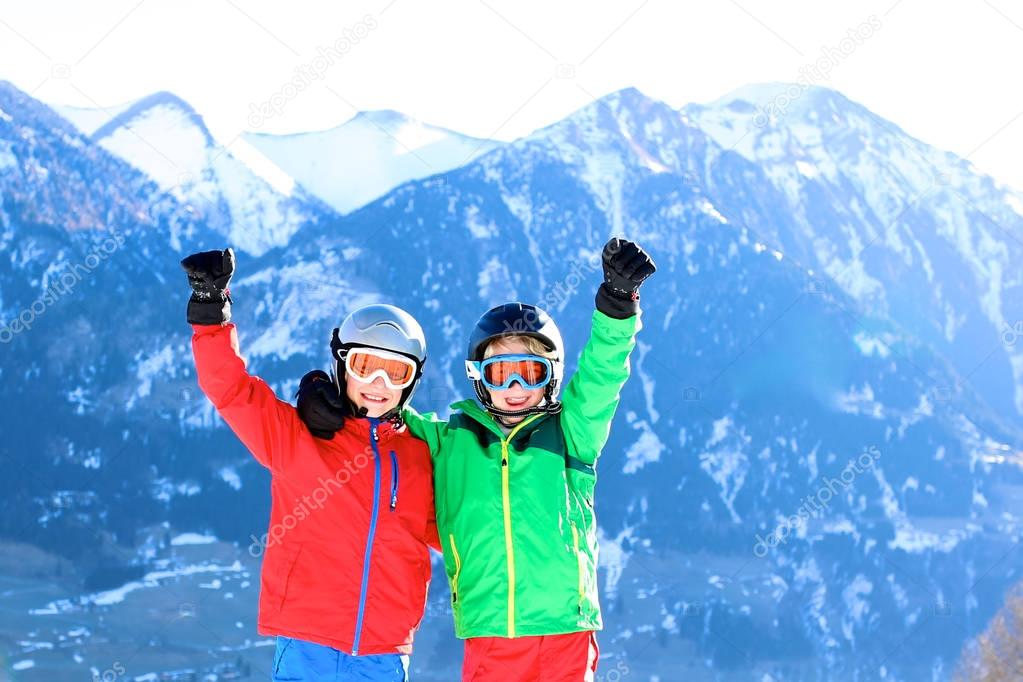 Two boys skiing in the mountains