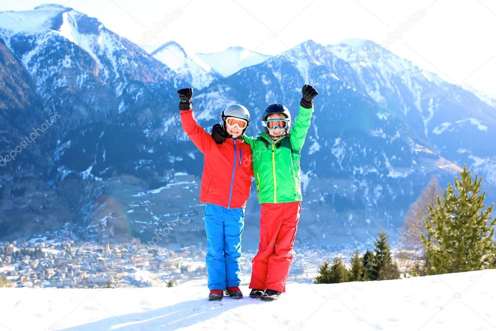 Happy kids skiing in the mountains