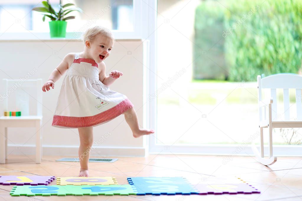 Little girl dancing indoors