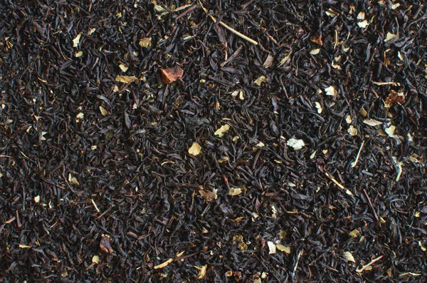 Getrockneter Schwarzer Tee Mit Zusatzstoffen Nahaufnahme Hintergrund — Stockfoto