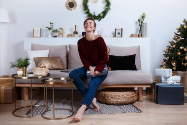 Genç kadın hediyeleri Noel ve yeni yıl için hazırlanıyor. Fotoğraf bir tatil iç yapılır