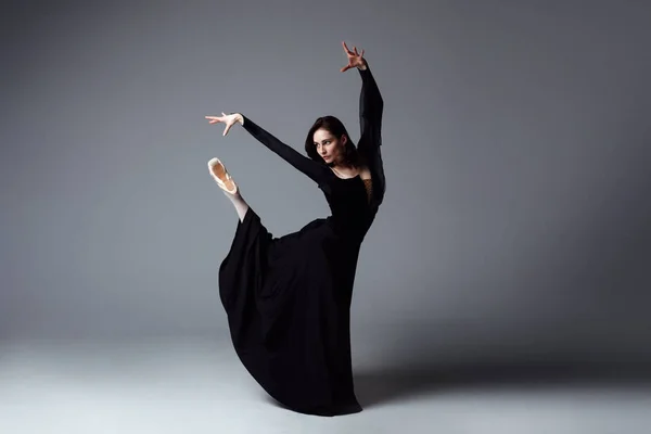 Bailarina delgada en un vestido largo negro —  Fotos de Stock