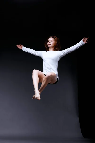 Young contemporary dancer is posing in studio