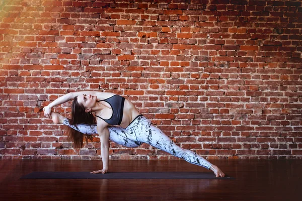 Jovem mulher esportiva está fazendo ioga — Fotografia de Stock