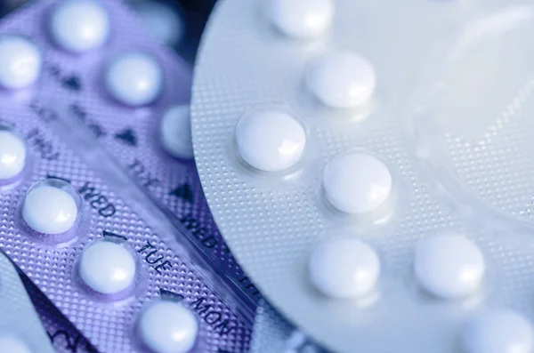 Oral contraceptive pill on pharmacy counter with colorful pills — Stock Photo, Image