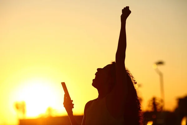 Silhouette Excited Woman Holding Phone Celebrating Success Sunset — Stock Photo, Image