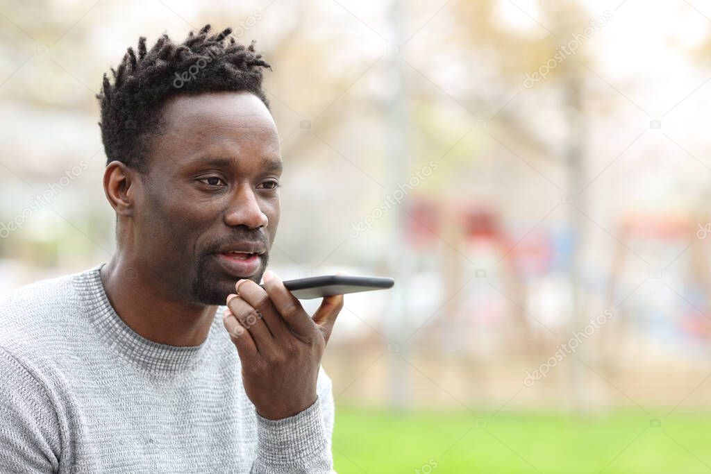 Black man using voice recognition system on phone