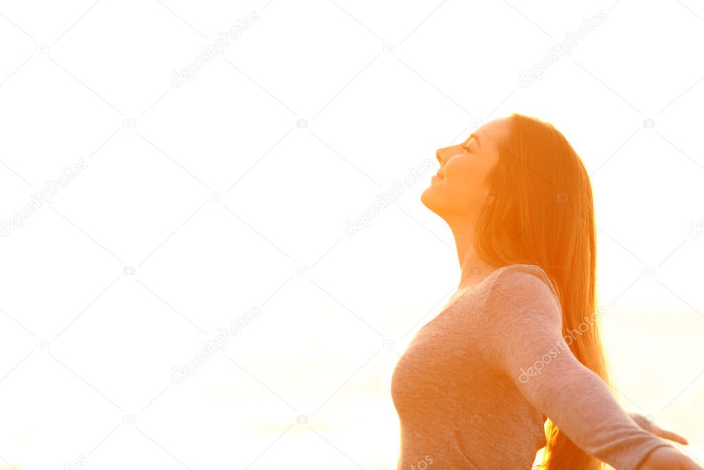 Profile of a woman breathing deep fresh air on white background