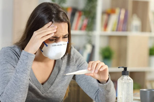 Worried Woman Wearing Protective Mask Covid Fever Symptoms Looking Thermometer — Stock Photo, Image