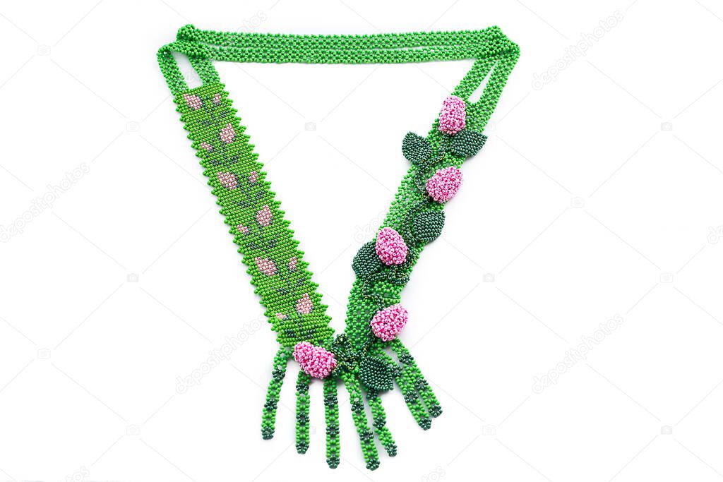 Beaded necklace with flowers or berries on black velvet bust isolated on white background. Female accessories, decorative ornaments and jewelry. Fashion and style concept.