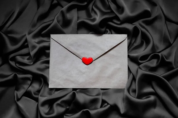 paper envelope with a heart on a black background