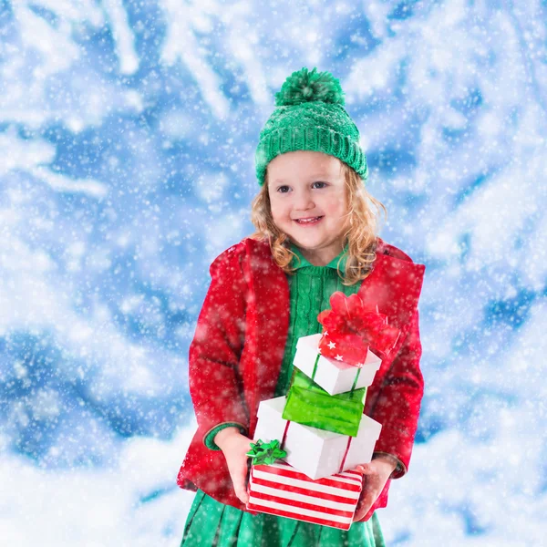 Little girl holding Christmas presents — Stock Photo, Image