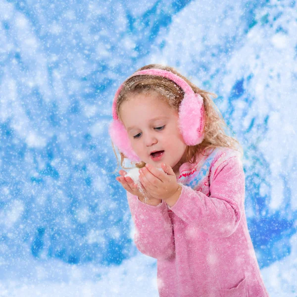 Little girl catching snow flakes