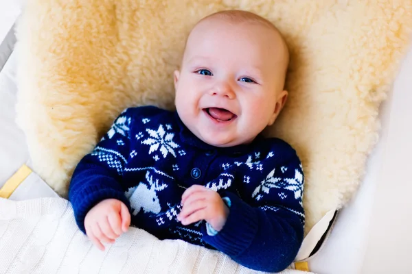 Little baby in nordic sweater on sheepskin muff — Φωτογραφία Αρχείου