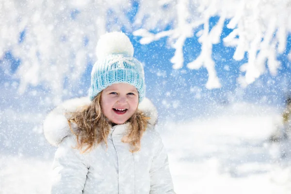 Barn har roligt i snöiga vinter park — Stockfoto