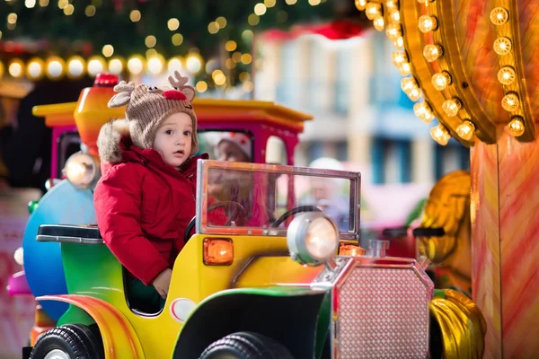 Child riding carousel on Christmas market — Stock Photo, Image