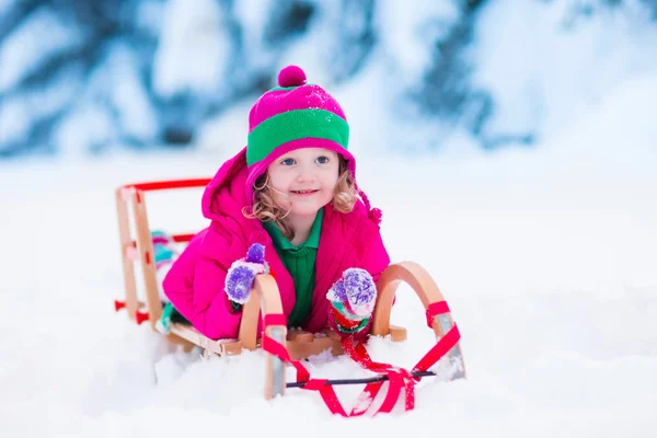 Little girl playing in snowy winter forest — Stock Photo, Image