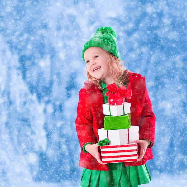 Little girl holding Christmas presents — Stock Photo, Image