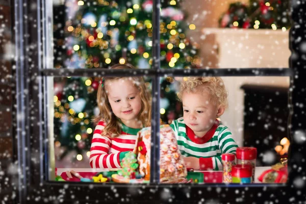 Barnen gör jul ingefära bröd hus — Stockfoto
