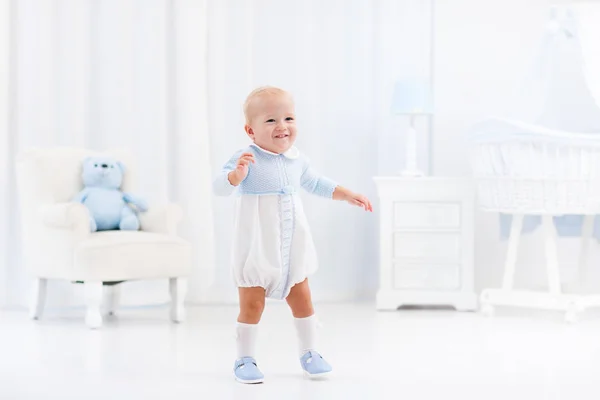 First steps of baby boy learning to walk