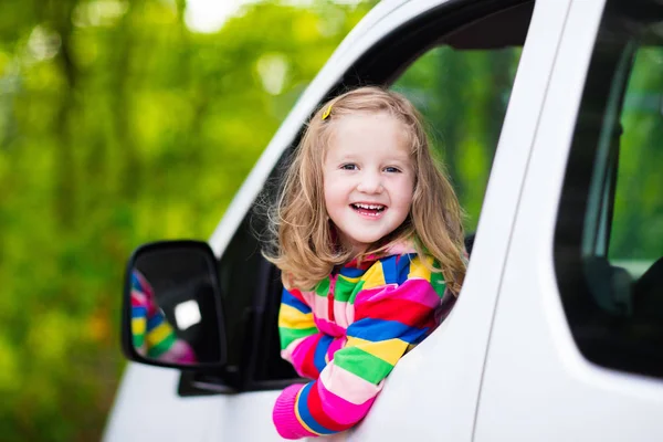 Little girl sitting in white car — Stock Photo, Image