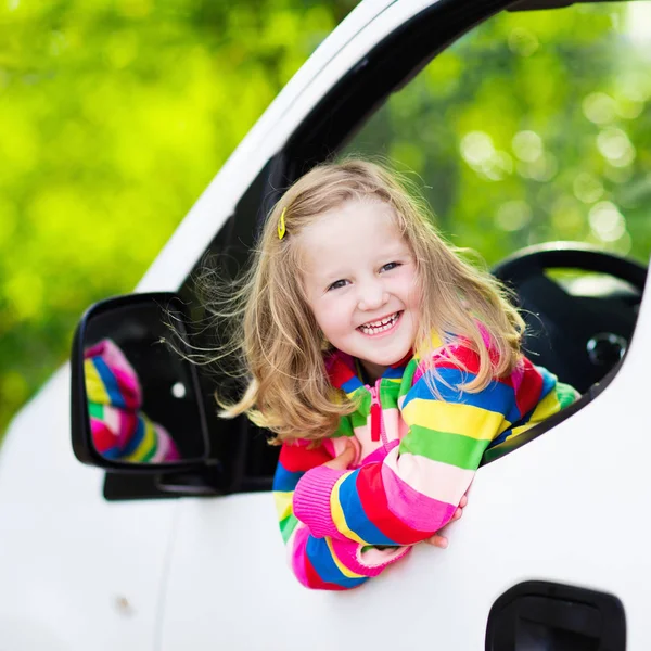 Little girl sitting in white car — Stock Photo, Image