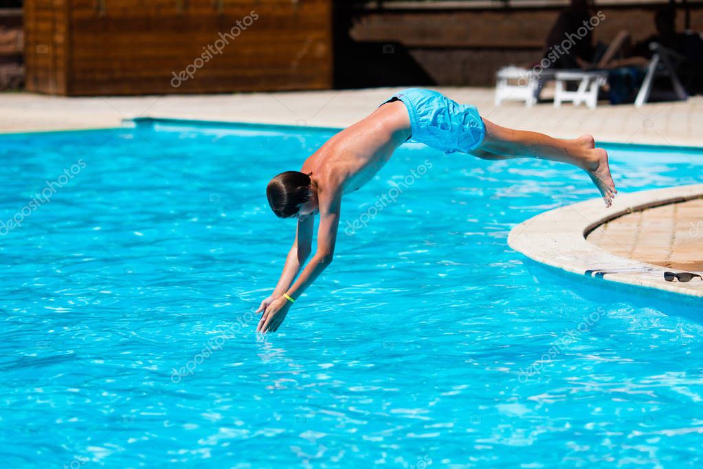 Boy diving in swimming pool — Stock Photo © FamVeldman 138369204
