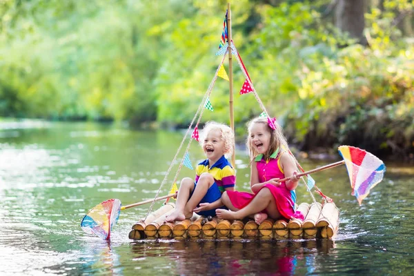 Kids on wooden raft — Stock Photo, Image