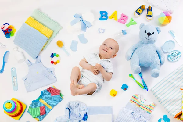 Bebé con ropa y artículos de cuidado infantil — Foto de Stock