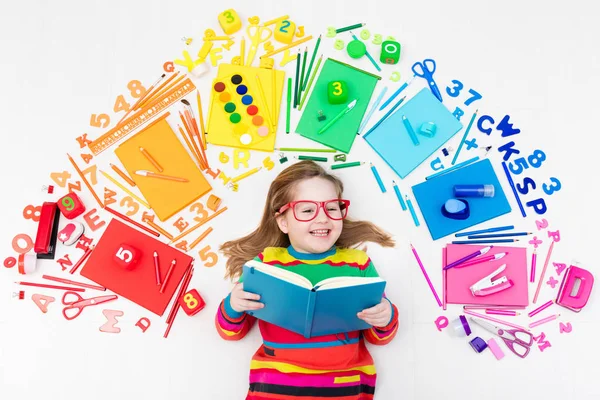 Child with school and drawing supplies. Student with book. — Stock Photo, Image