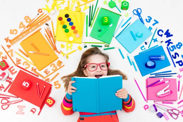 Child with school and drawing supplies. Student with book. — Stock Photo, Image