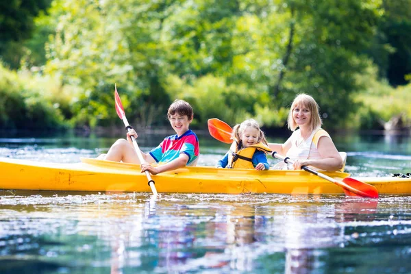 Família desfrutando de passeio de caiaque em um rio — Fotografia de Stock