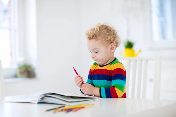 Los niños leen, escriben y pintan. Niño haciendo la tarea . — Foto de Stock