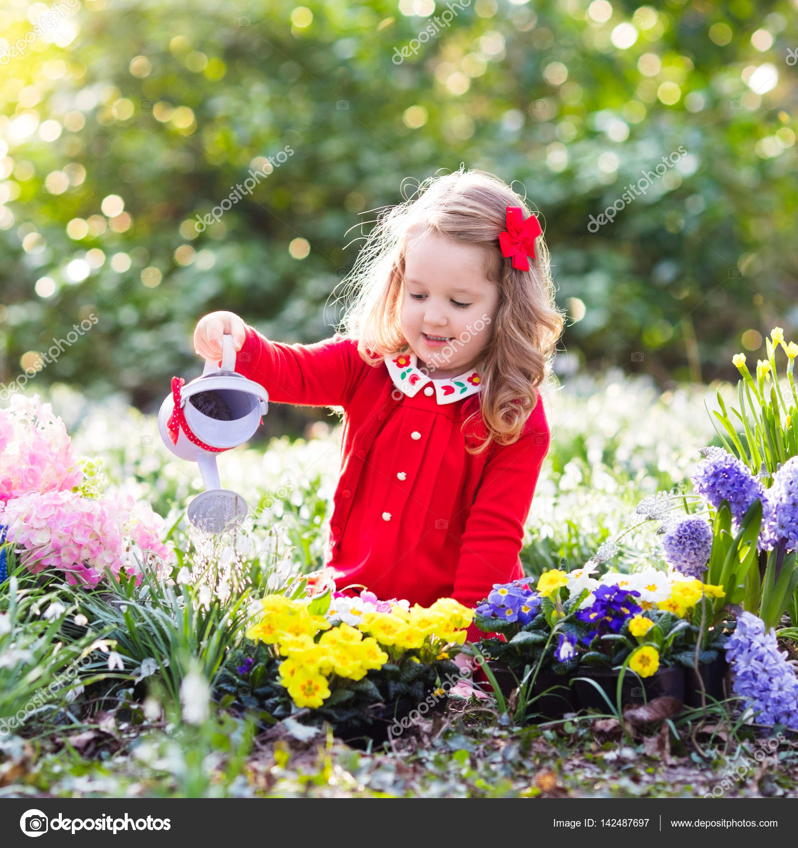 Kids Plant And Water Flowers In Spring Garden Stock Photo C Famveldman