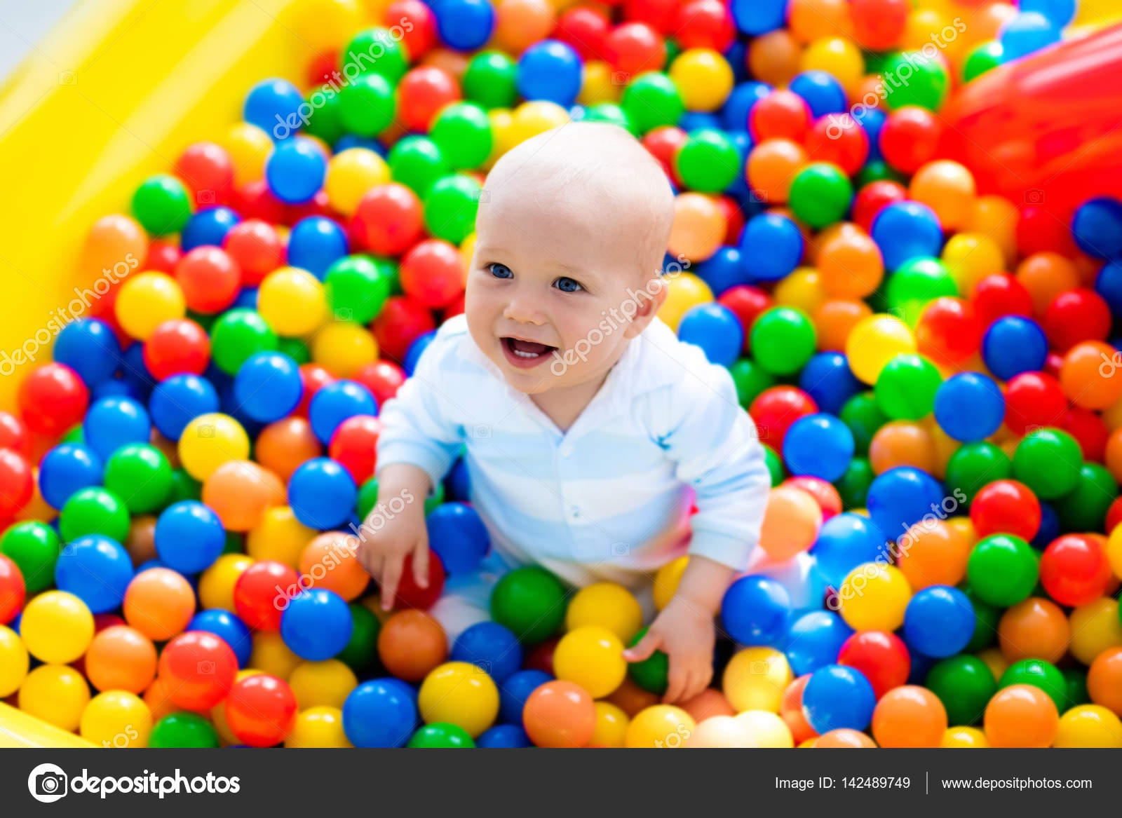child playing in ball pit on indoor playground stock photo image by c famveldman 142489749