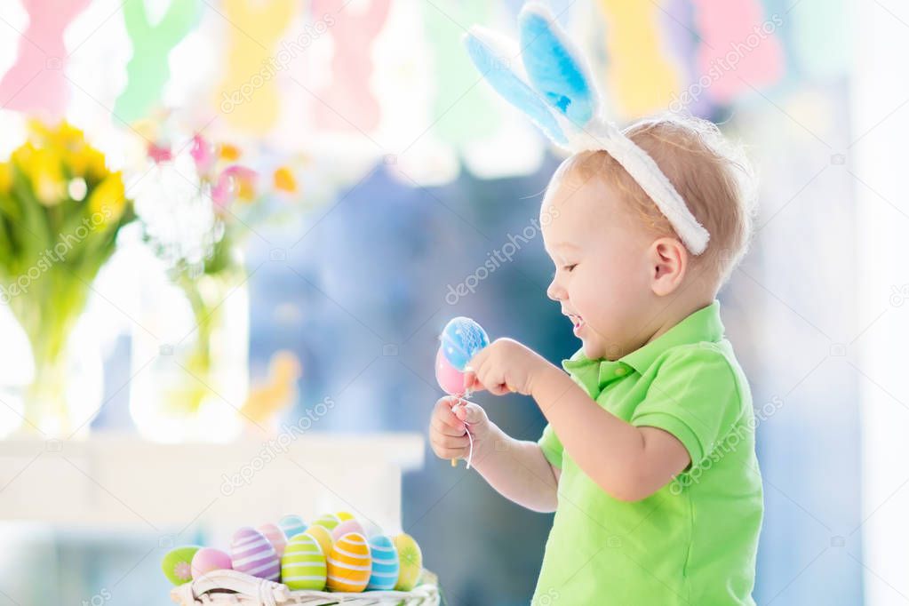 Baby with bunny ears on Easter egg hunt